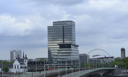 Der Lanxess Tower in Köln mit Brücke und Arena im Hintergrund